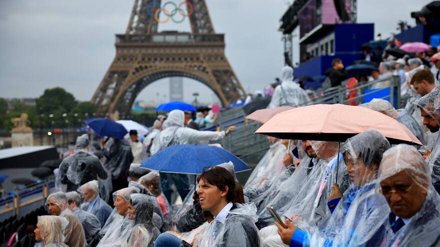 El público comienza a ocupar bajo la lluvia las gradas del Trocadero